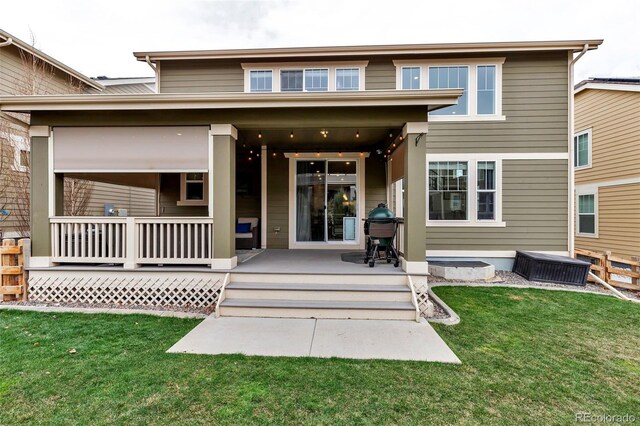 rear view of house featuring a lawn