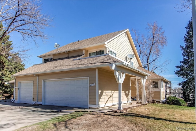 view of property exterior with a yard, a garage, and concrete driveway