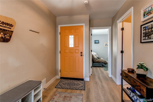 entrance foyer featuring baseboards and light wood-style flooring