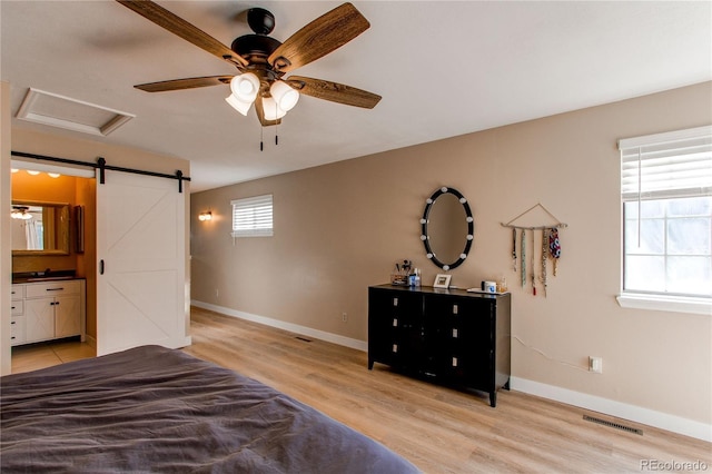 unfurnished bedroom featuring visible vents, multiple windows, and light wood finished floors