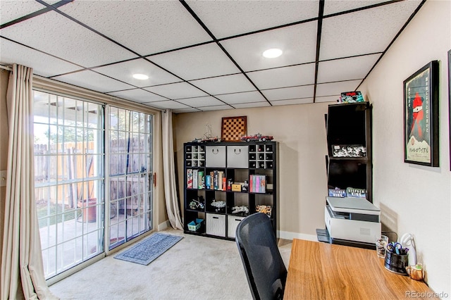 carpeted office featuring baseboards and a paneled ceiling
