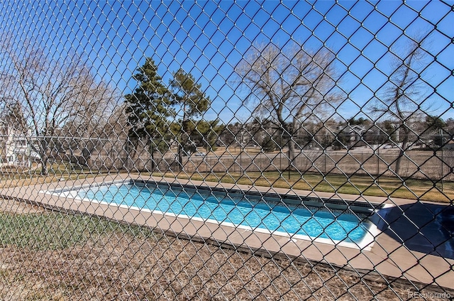 view of swimming pool with a fenced in pool and fence