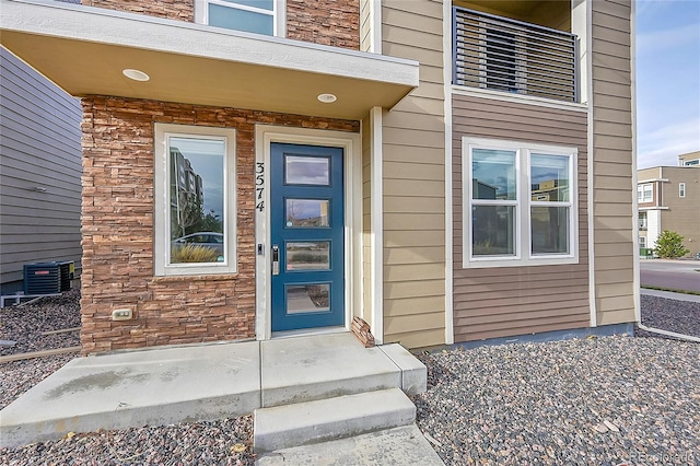 doorway to property with central AC unit