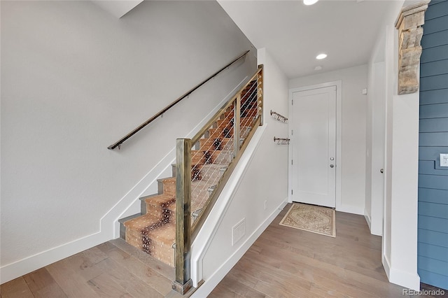 stairway featuring hardwood / wood-style floors