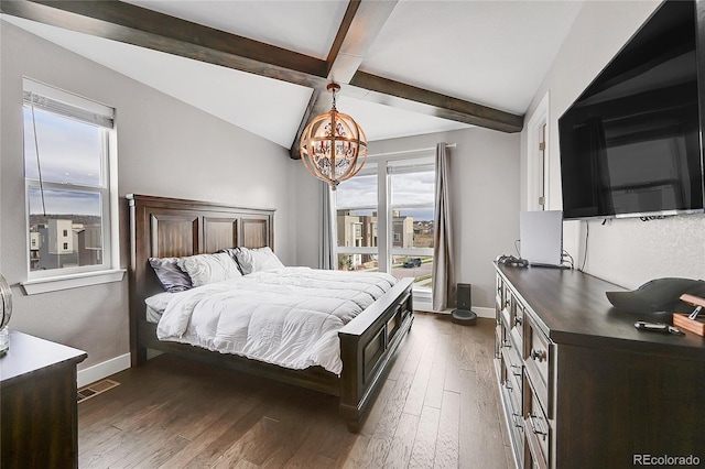 bedroom featuring beamed ceiling, dark wood-type flooring, and a chandelier