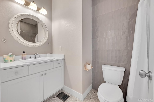 bathroom featuring vanity, tile patterned flooring, curtained shower, and toilet