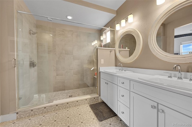 bathroom with tile patterned floors, vanity, and a shower with door