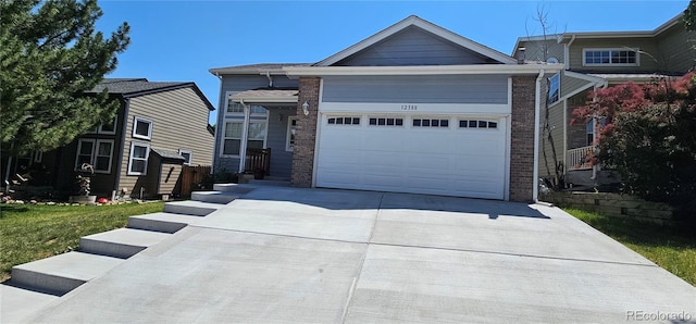 12388 Jasmine St, Brighton, CO 80602 - view of front facade featuring driveway and a garage