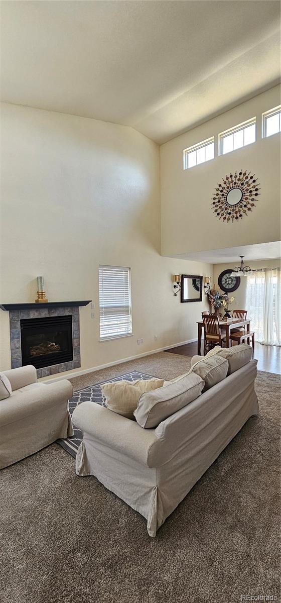 12388 Jasmine St, Brighton, CO 80602 - living area featuring a high ceiling and a fireplace