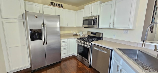 12388 Jasmine St, Brighton, CO 80602 - kitchen with stainless steel appliances, dark wood-style floors, light countertops, and white cabinetry