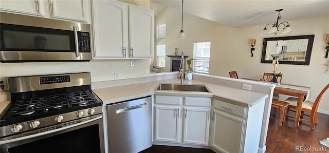 12388 Jasmine St, Brighton, CO 80602 - kitchen with stainless steel appliances, a peninsula, light countertops, and white cabinets