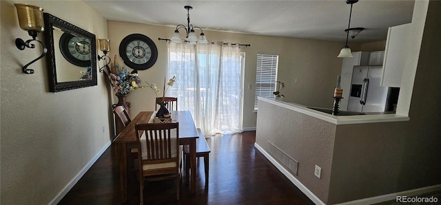 12388 Jasmine St, Brighton, CO 80602 - dining room with a chandelier, a textured wall, and dark wood-style flooring