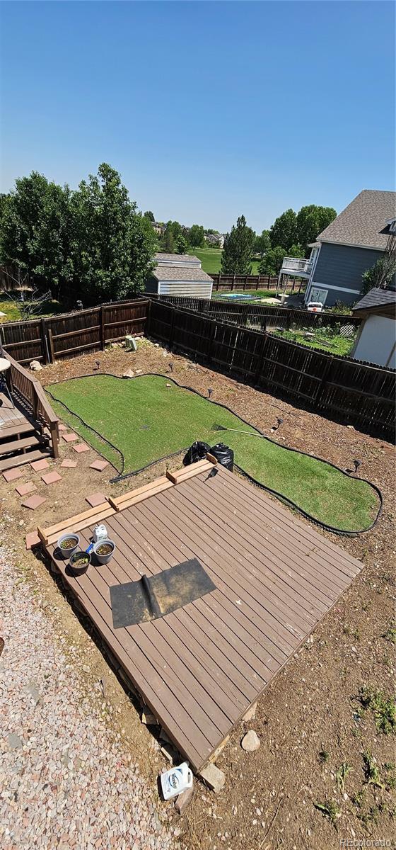 12388 Jasmine St, Brighton, CO 80602 - wooden terrace with a fenced backyard