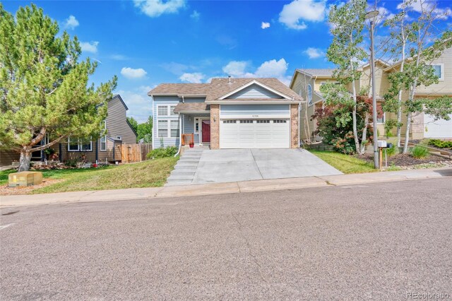 12388 Jasmine St, Brighton, CO 80602 - view of front of house featuring a garage, driveway, and brick siding