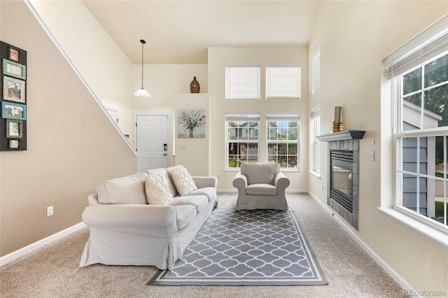 12388 Jasmine St, Brighton, CO 80602 - carpeted living area with a glass covered fireplace and a high ceiling