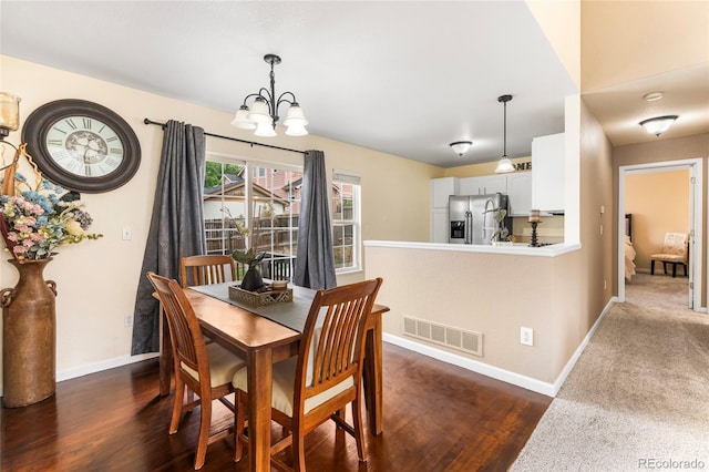 12388 Jasmine St, Brighton, CO 80602 - dining area featuring a chandelier and dark wood-style flooring