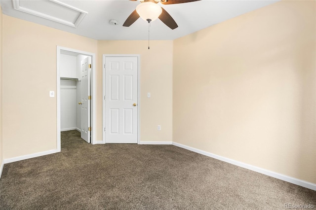 12388 Jasmine St, Brighton, CO 80602 - unfurnished bedroom with attic access, dark carpet, a spacious closet, and a ceiling fan