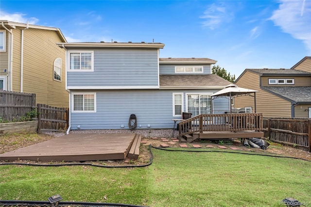 12388 Jasmine St, Brighton, CO 80602 - rear view of property with a wooden deck, a fenced backyard, and a gazebo