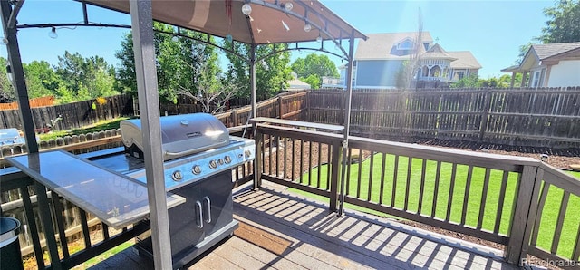 12388 Jasmine St, Brighton, CO 80602 - wooden deck featuring a fenced backyard and grilling area