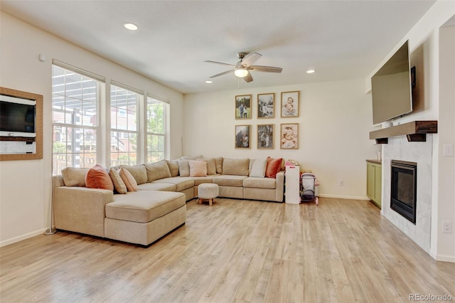 4863 Wildflower Pl, Dacono, CO 80514 - living area featuring light wood finished floors, a ceiling fan, a glass covered fireplace, and recessed lighting