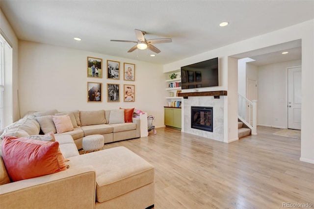 4863 Wildflower Pl, Dacono, CO 80514 - living room with ceiling fan, recessed lighting, light wood-type flooring, a fireplace, and stairway