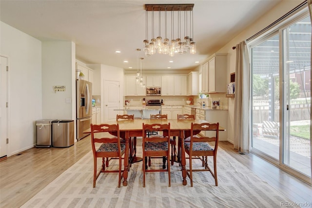 4863 Wildflower Pl, Dacono, CO 80514 - dining area featuring light wood-type flooring, healthy amount of natural light, a chandelier, and recessed lighting
