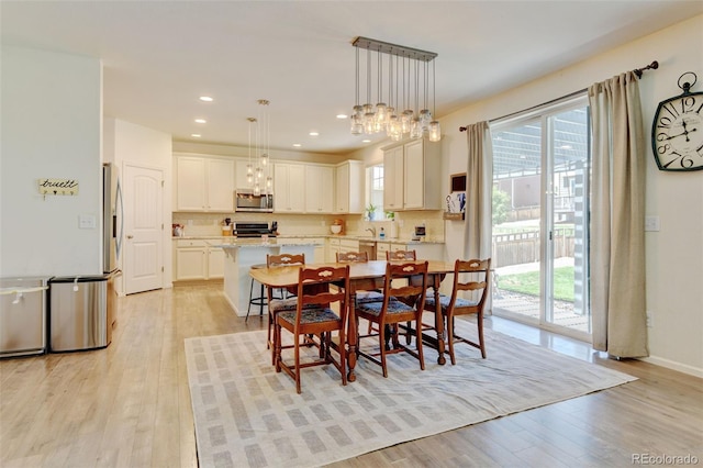 4863 Wildflower Pl, Dacono, CO 80514 - dining room featuring light wood-style floors, plenty of natural light, recessed lighting, and a chandelier