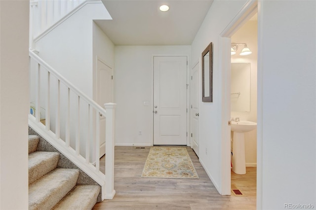 4863 Wildflower Pl, Dacono, CO 80514 - entryway featuring wood finished floors, stairs, and recessed lighting