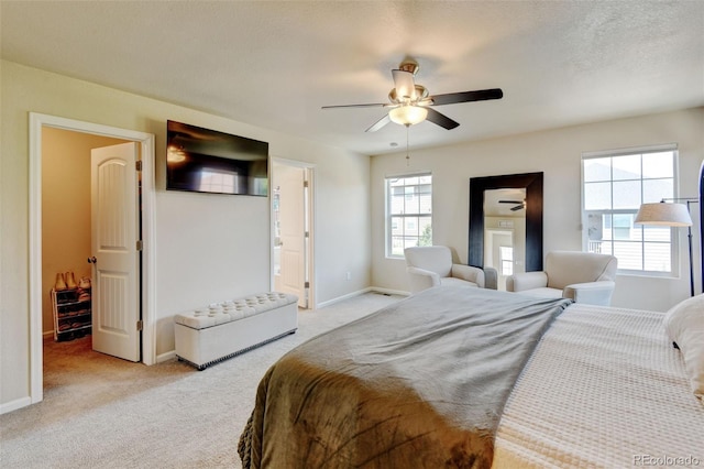 4863 Wildflower Pl, Dacono, CO 80514 - bedroom with light carpet, ceiling fan, and connected bathroom