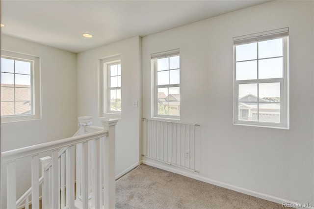 4863 Wildflower Pl, Dacono, CO 80514 - hallway featuring an upstairs landing, light colored carpet, radiator heating unit, and recessed lighting