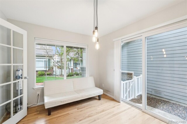 living area with wood finished floors and baseboards
