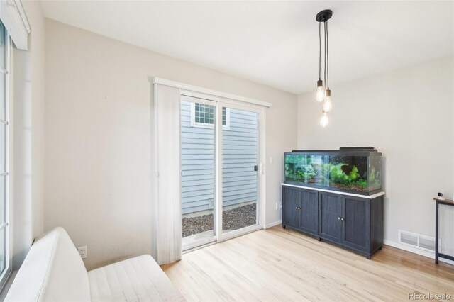 unfurnished living room featuring light wood-style flooring and baseboards
