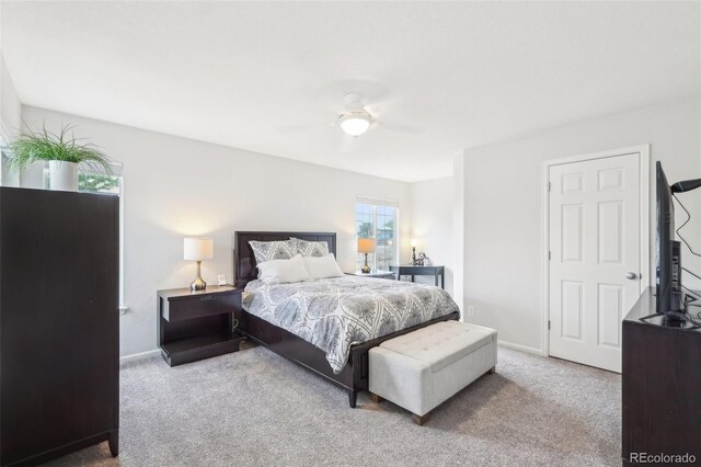 carpeted bedroom with ceiling fan and baseboards