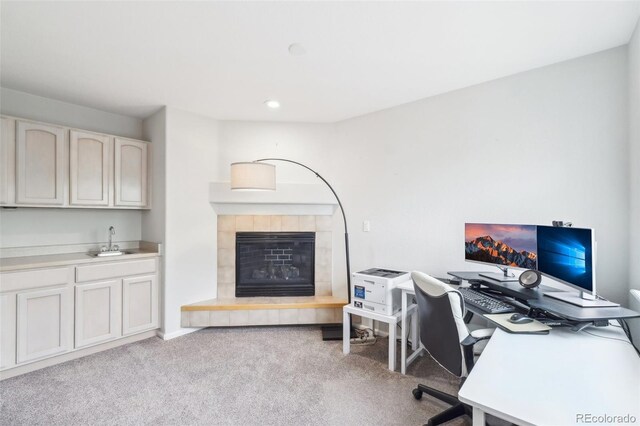 home office featuring carpet floors, wet bar, recessed lighting, a fireplace, and baseboards
