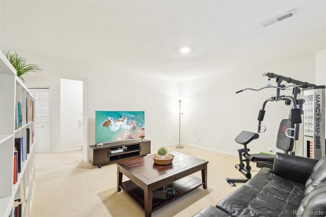 living area featuring light colored carpet and baseboards