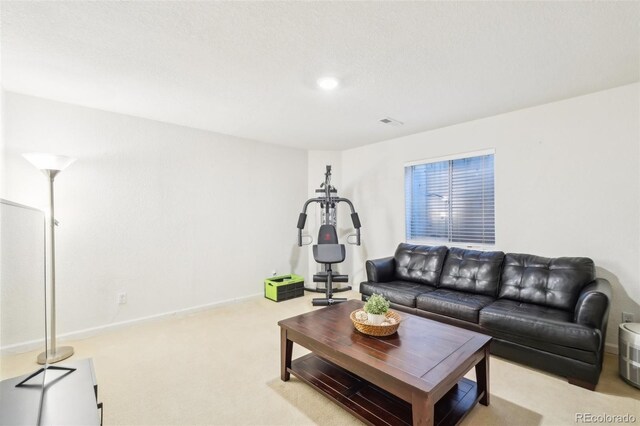 carpeted living area with baseboards