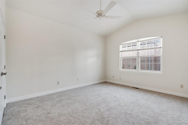 carpeted empty room featuring vaulted ceiling and ceiling fan