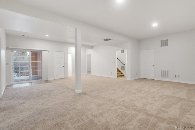 basement featuring light carpet