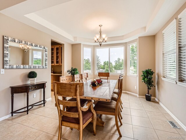 8522 S Dudley St, Littleton, CO 80128 - dining area featuring a chandelier, a raised ceiling, and light tile patterned flooring