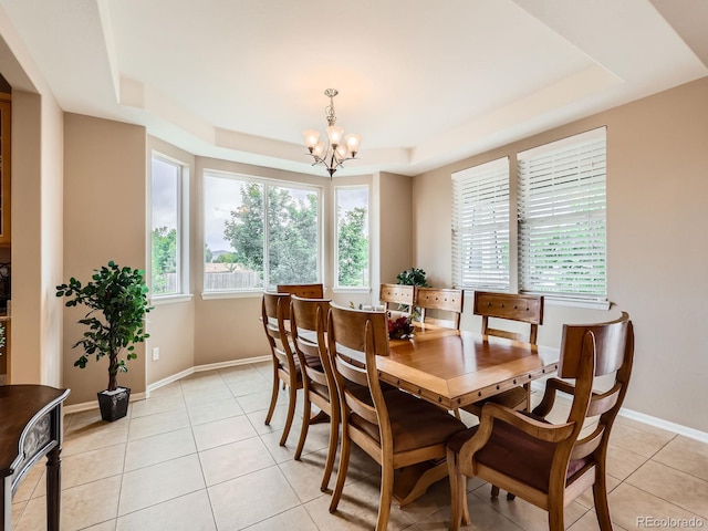 8522 S Dudley St, Littleton, CO 80128 - dining space with a tray ceiling, a chandelier, and light tile patterned floors