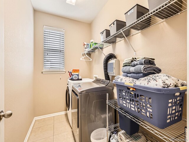 8522 S Dudley St, Littleton, CO 80128 - laundry area with washing machine and clothes dryer and tile patterned flooring