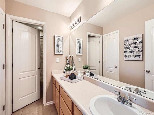 8522 S Dudley St, Littleton, CO 80128 - bathroom featuring tile patterned flooring and vanity