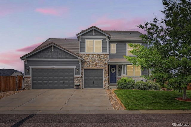 8522 S Dudley St, Littleton, CO 80128 - craftsman inspired home featuring stone siding, driveway, a garage, and a porch