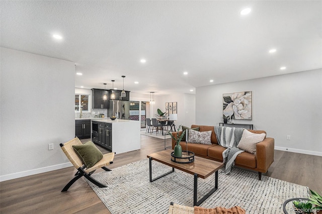 living area with recessed lighting, baseboards, and wood finished floors