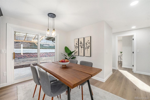 dining area with light wood-style floors, baseboards, and recessed lighting