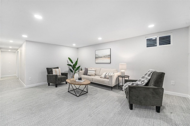 carpeted living area featuring recessed lighting and baseboards