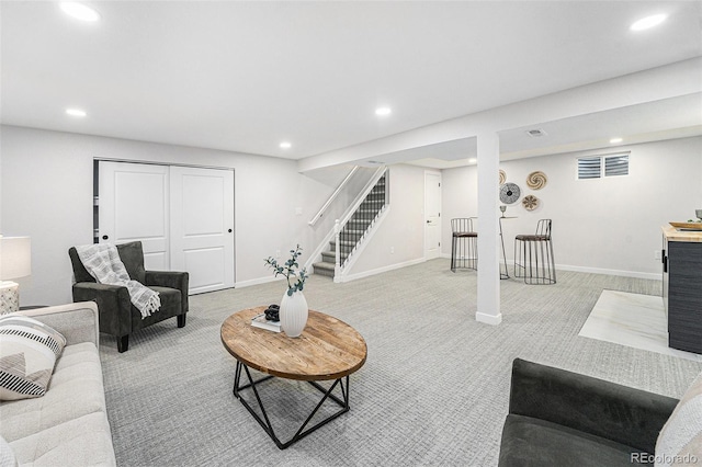 living area featuring visible vents, baseboards, light colored carpet, stairway, and recessed lighting