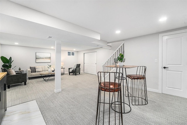 interior space with light carpet, visible vents, stairway, and recessed lighting