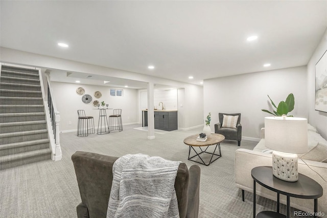 carpeted living room featuring recessed lighting, visible vents, stairway, a bar, and baseboards