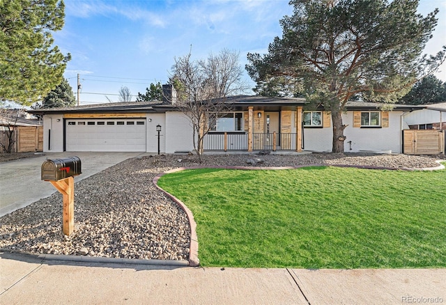 single story home with driveway, a chimney, an attached garage, covered porch, and a front yard